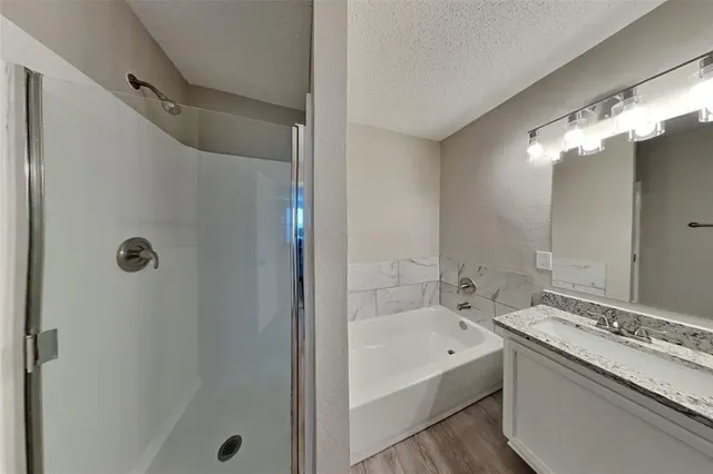 a bathroom with a bathtub and a shower