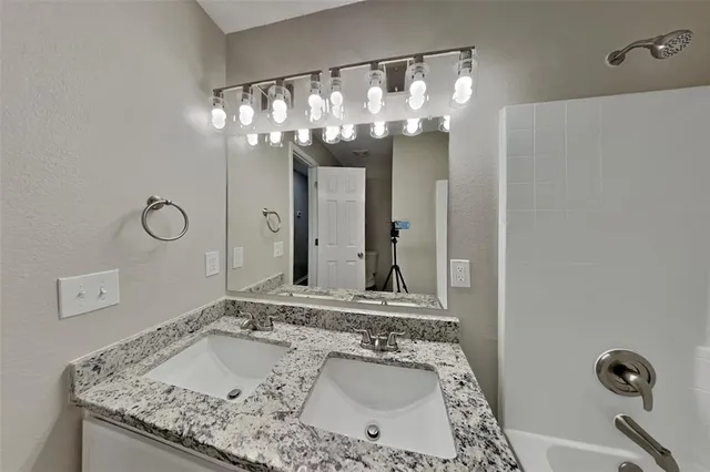 a bathroom with a sink vanity and a mirror