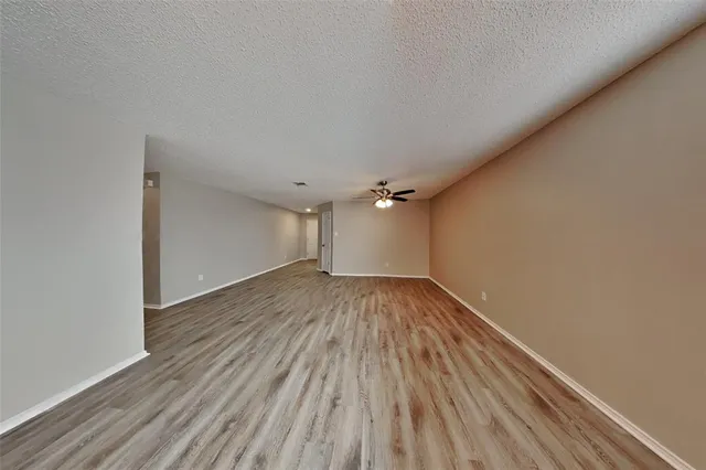 a view of a room with wooden floor