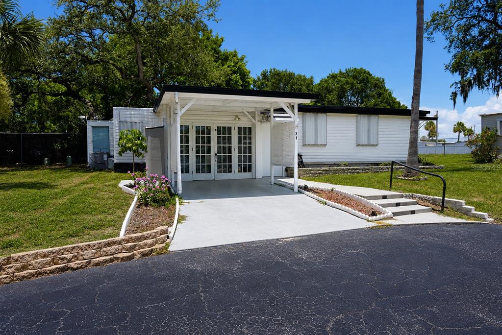 980 7th Street Northwest, Unit 71 Largo, FL 33770 - Photo 2 of 23 a view of a house with backyard and a tree