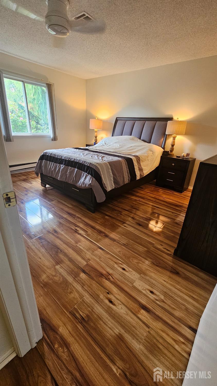 449 B Closter Road, Unit B Monroe Township, NJ 08831 - Photo 9 of 14 a bedroom with a bed and a night stand