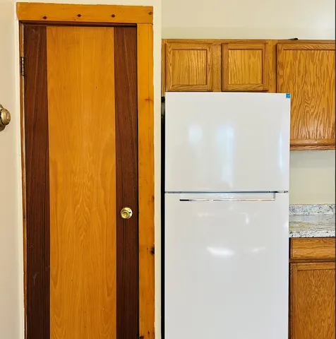 a white refrigerator freezer sitting in a kitchen