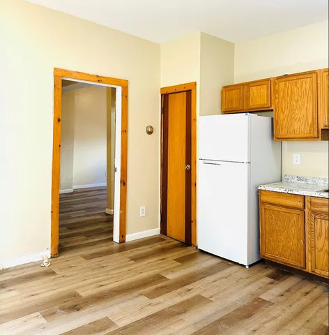 a view of a kitchen with a refrigerator and a stove