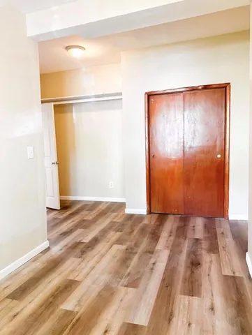 a view of a room with wooden floor