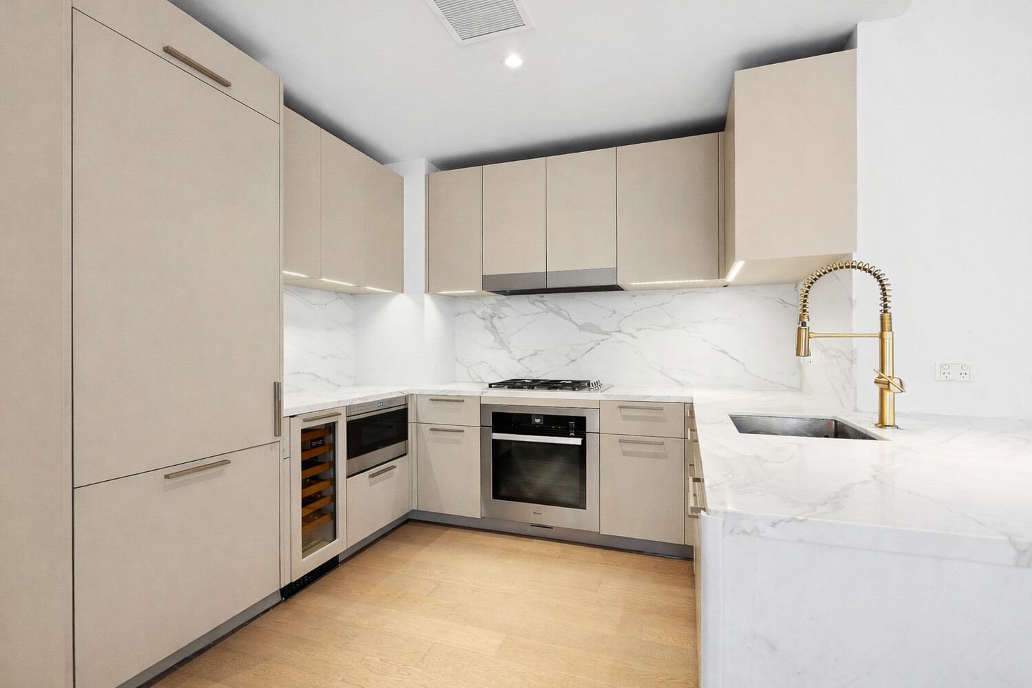 305 East 51st Street, Unit RU5F Manhattan, NY 10022 - Photo 3 of 13 a kitchen with granite countertop white cabinets and stainless steel appliances