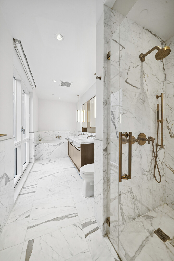 305 East 51st Street, Unit RU5F Manhattan, NY 10022 - Photo 7 of 13 a large white bathroom with mirror and shower