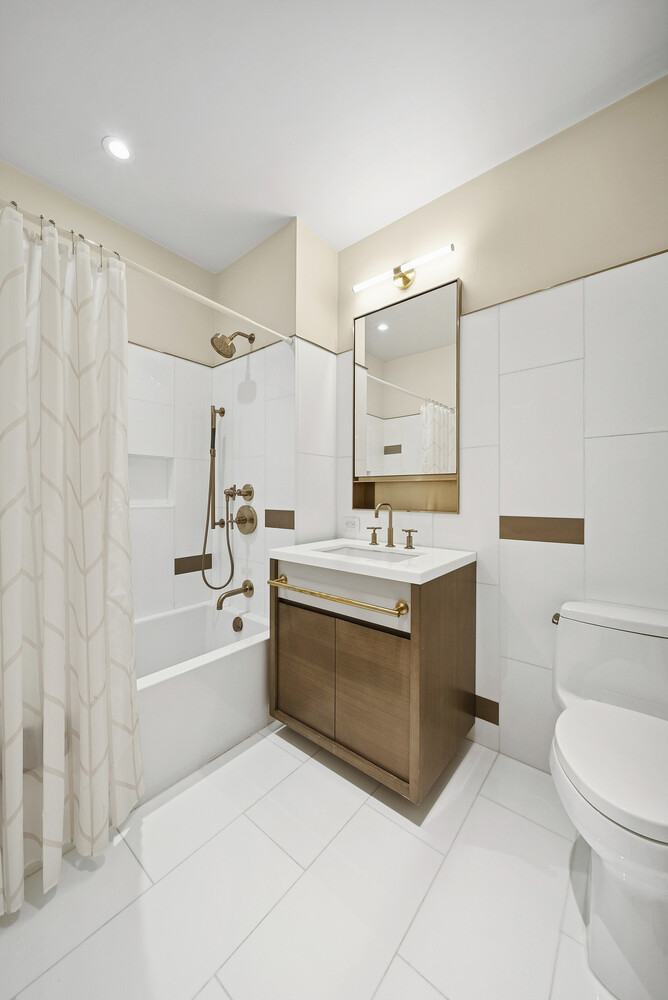 305 East 51st Street, Unit RU5F Manhattan, NY 10022 - Photo 9 of 13 a bathroom with a sink a toilet and shower