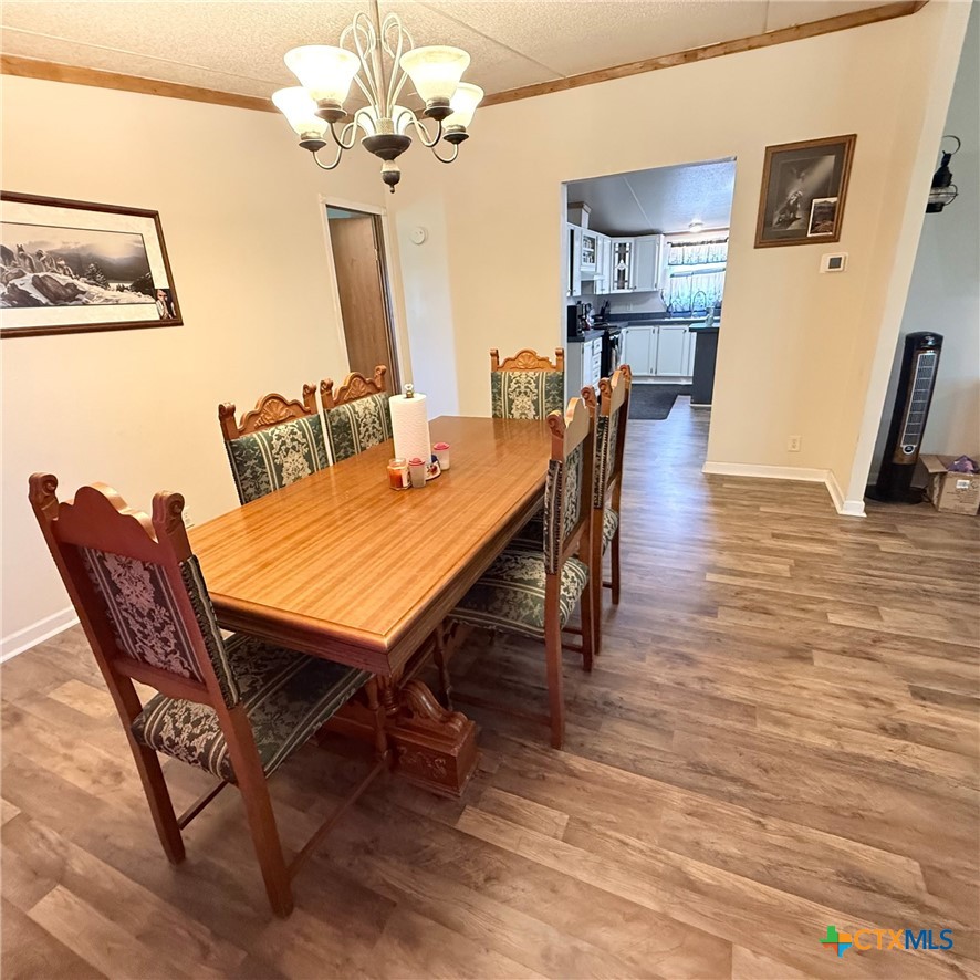 850 Blakely Road Gatesville, TX 76528 - Photo 25 of 32 a view of a dining room with furniture and a chandelier