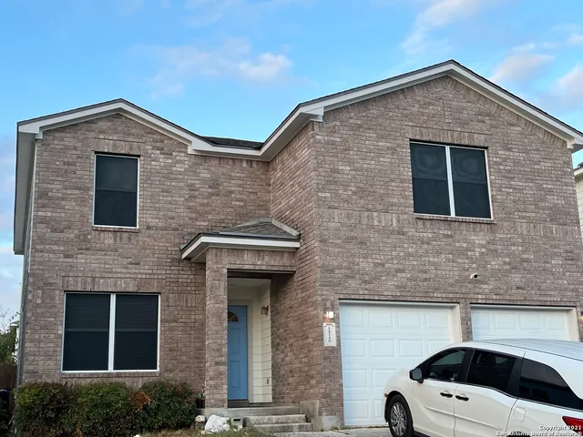 a front view of a house with garage