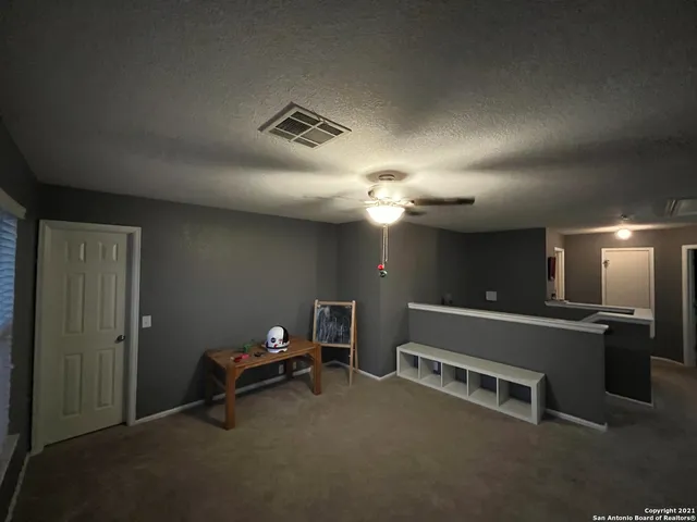 a bedroom with a bed window and couch