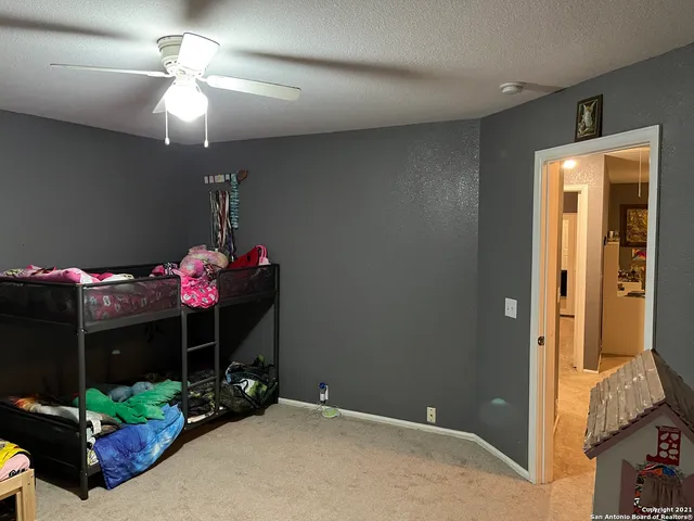 a backyard of a house with fire pit and chairs