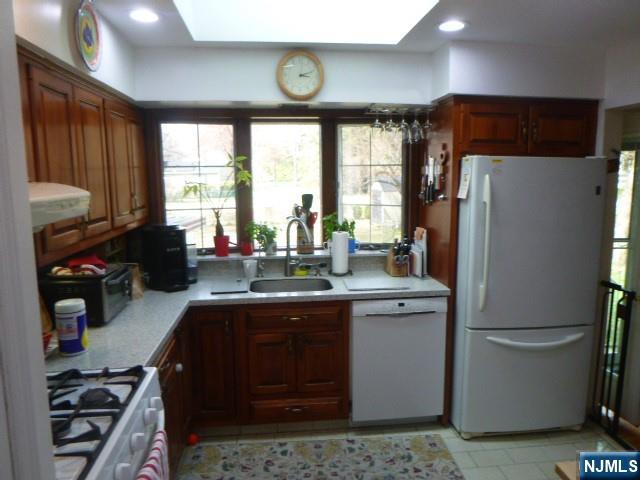 249 Madison Avenue Cresskill, NJ 07626 - Photo 12 of 26 a kitchen with stainless steel appliances granite countertop a sink stove and refrigerator
