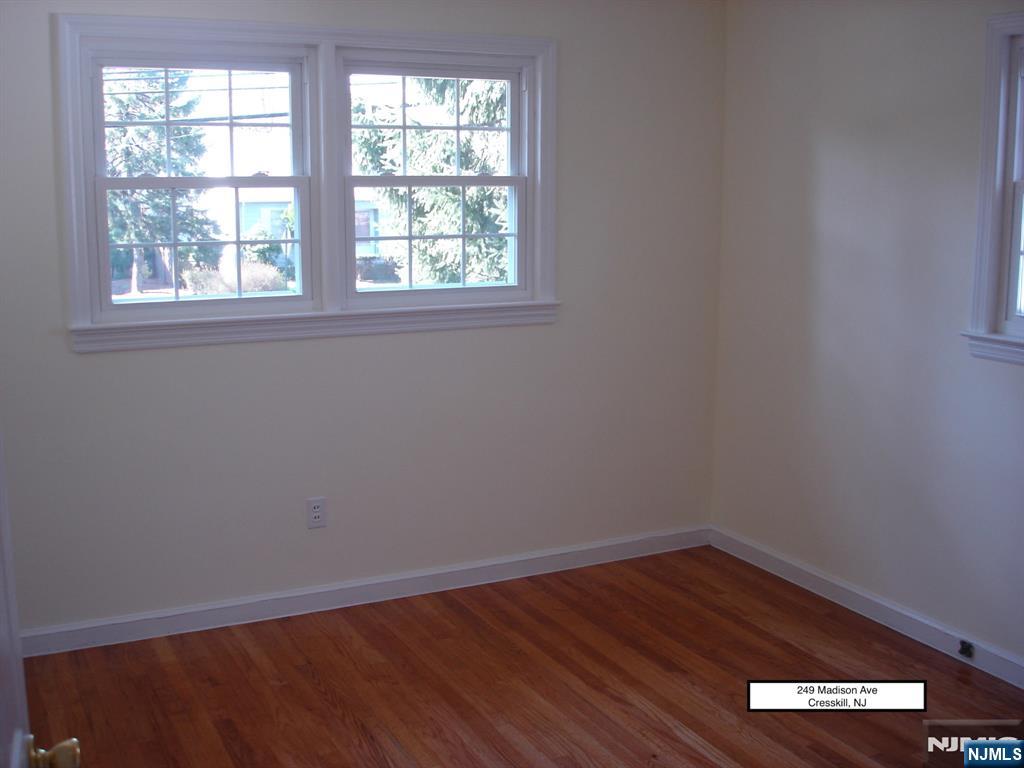 249 Madison Avenue Cresskill, NJ 07626 - Photo 19 of 26 an empty room with wooden floor and windows