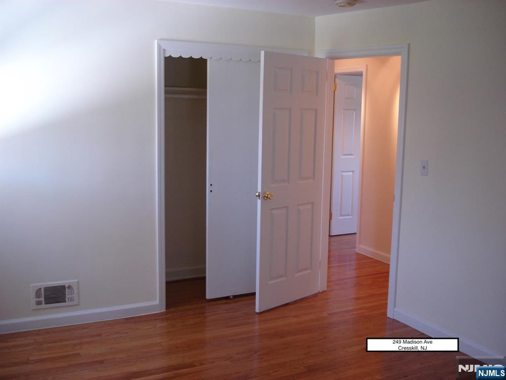 249 Madison Avenue Cresskill, NJ 07626 - Photo 21 of 26 an empty room with wooden floor and closet