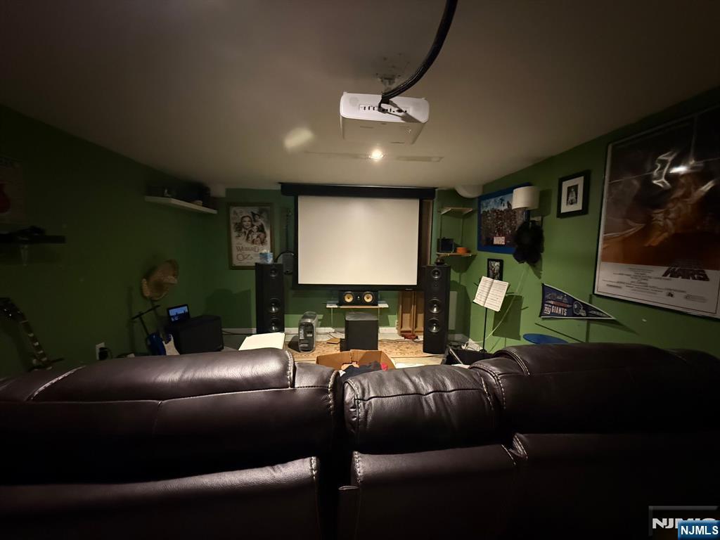 249 Madison Avenue Cresskill, NJ 07626 - Photo 25 of 26 a media room with lots of chairs and a projector screen