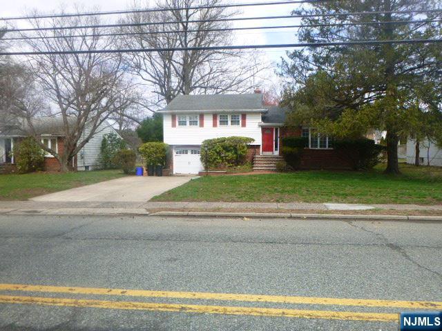 249 Madison Avenue Cresskill, NJ 07626 - Photo 3 of 26 a view of a house with a yard and large trees