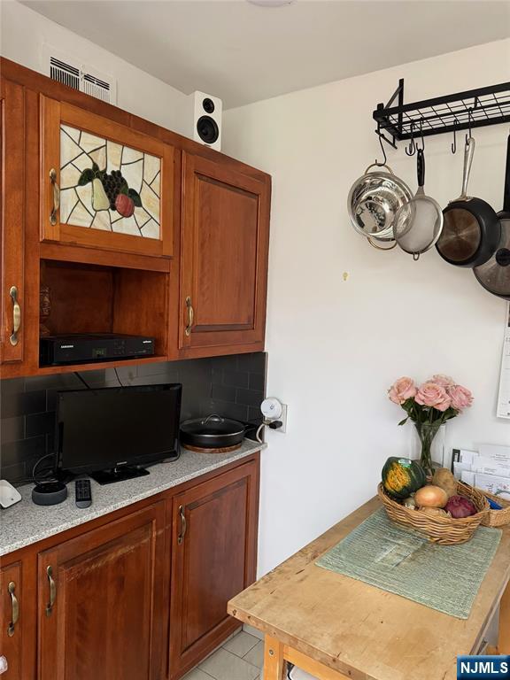 249 Madison Avenue Cresskill, NJ 07626 - Photo 8 of 26 a kitchen with stainless steel appliances a stove a microwave and cabinets