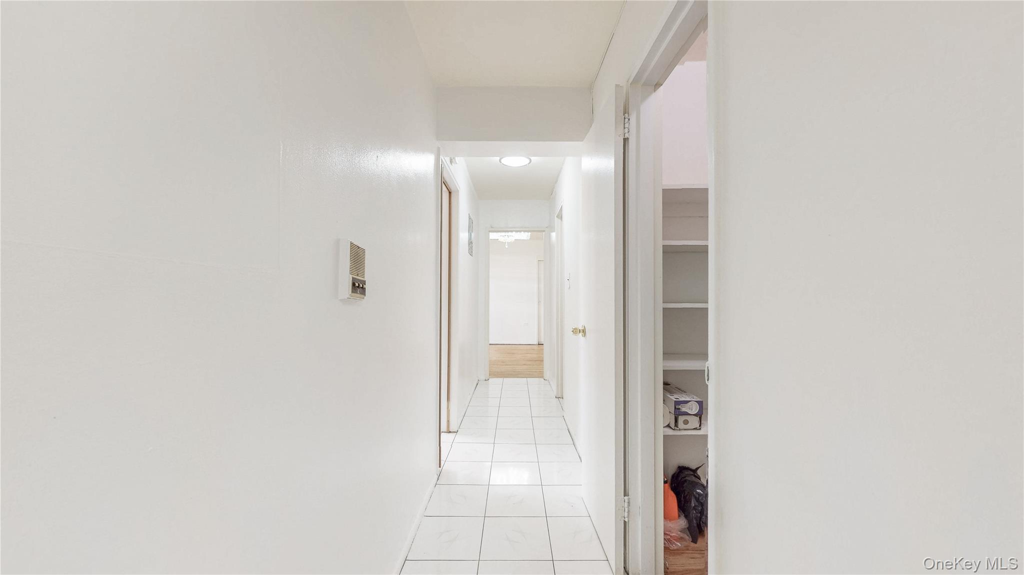99-35 59th Avenue, Unit 4E Queens, NY 11368 - Photo 12 of 22 Hallway with light tile patterned flooring