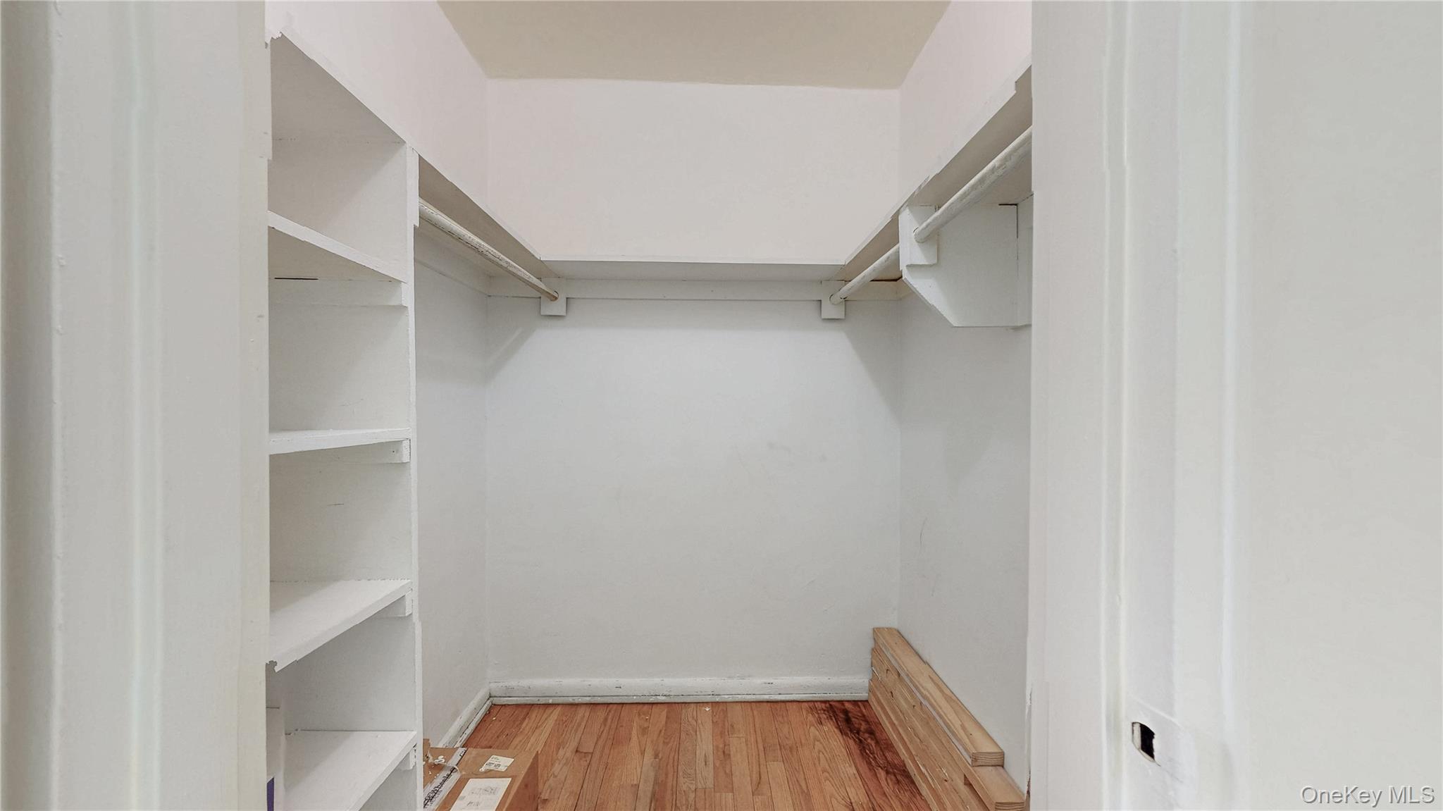 99-35 59th Avenue, Unit 4E Queens, NY 11368 - Photo 13 of 22 Spacious walk in closet with light wood-type flooring