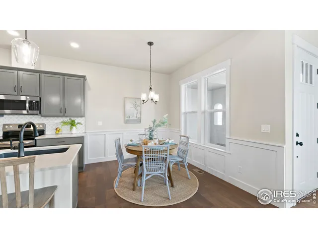 a kitchen with a table chairs refrigerator and cabinets
