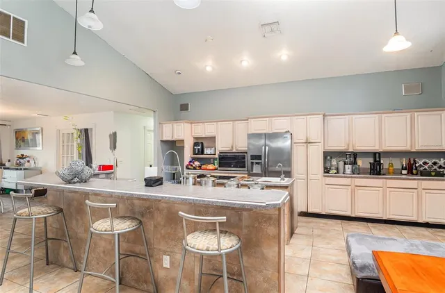 a kitchen with stainless steel appliances kitchen island granite countertop a sink and cabinets
