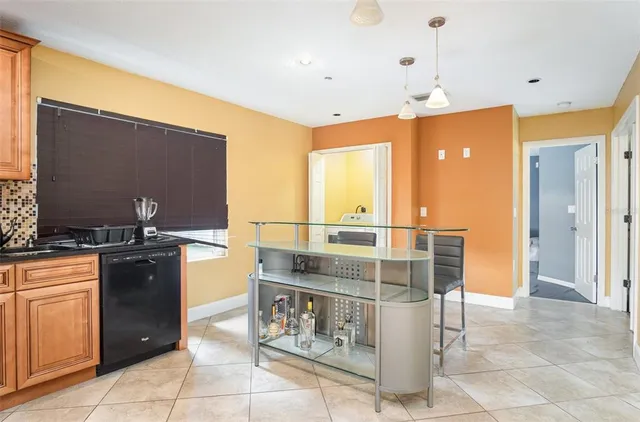 a kitchen with stainless steel appliances kitchen island granite countertop a refrigerator and microwave