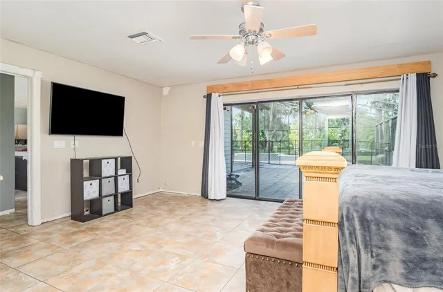 a spacious bedroom with a bed and a dresser