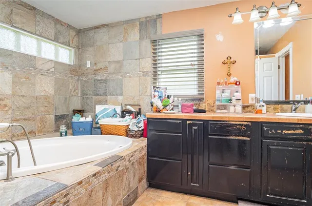 a bathroom with a granite countertop sink a shower and a mirror