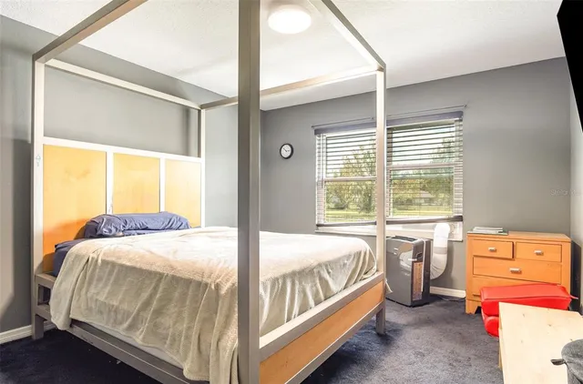 a bedroom with a bed and a flat tv screen