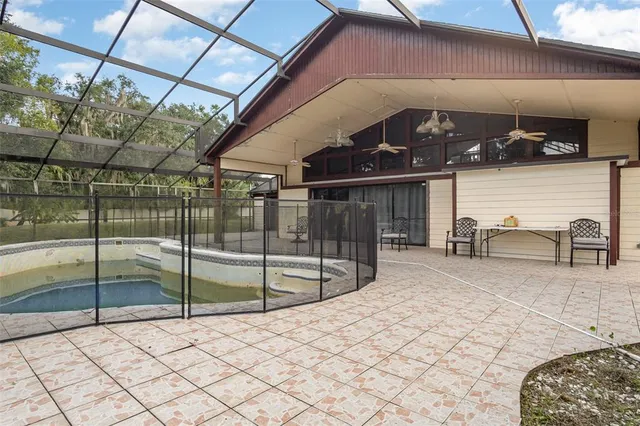 a view of a swimming pool and lounge chairs