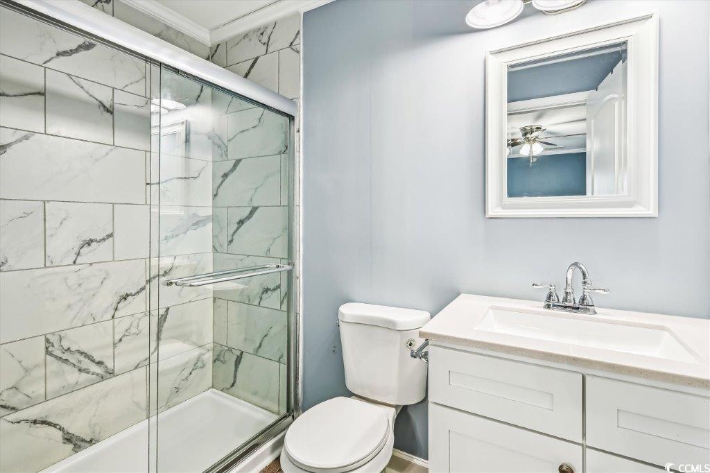 931 South Ocean Boulevard North Myrtle Beach, SC 29582 - Photo 12 of 40 Bathroom featuring an enclosed shower, vanity, crown molding, and ceiling fan