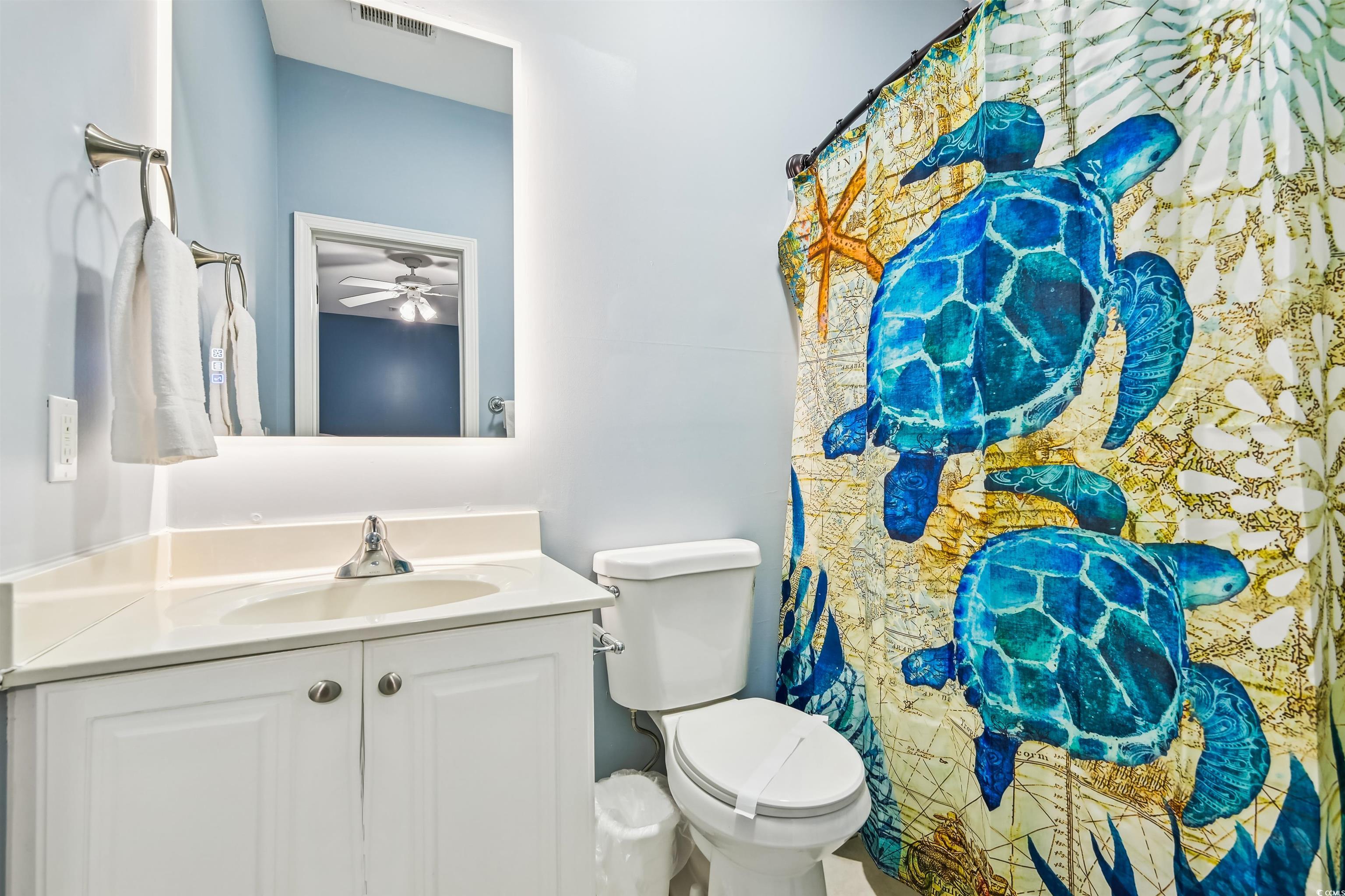 931 South Ocean Boulevard North Myrtle Beach, SC 29582 - Photo 14 of 40 Bathroom with vanity, a shower with shower curtain, and a ceiling fan