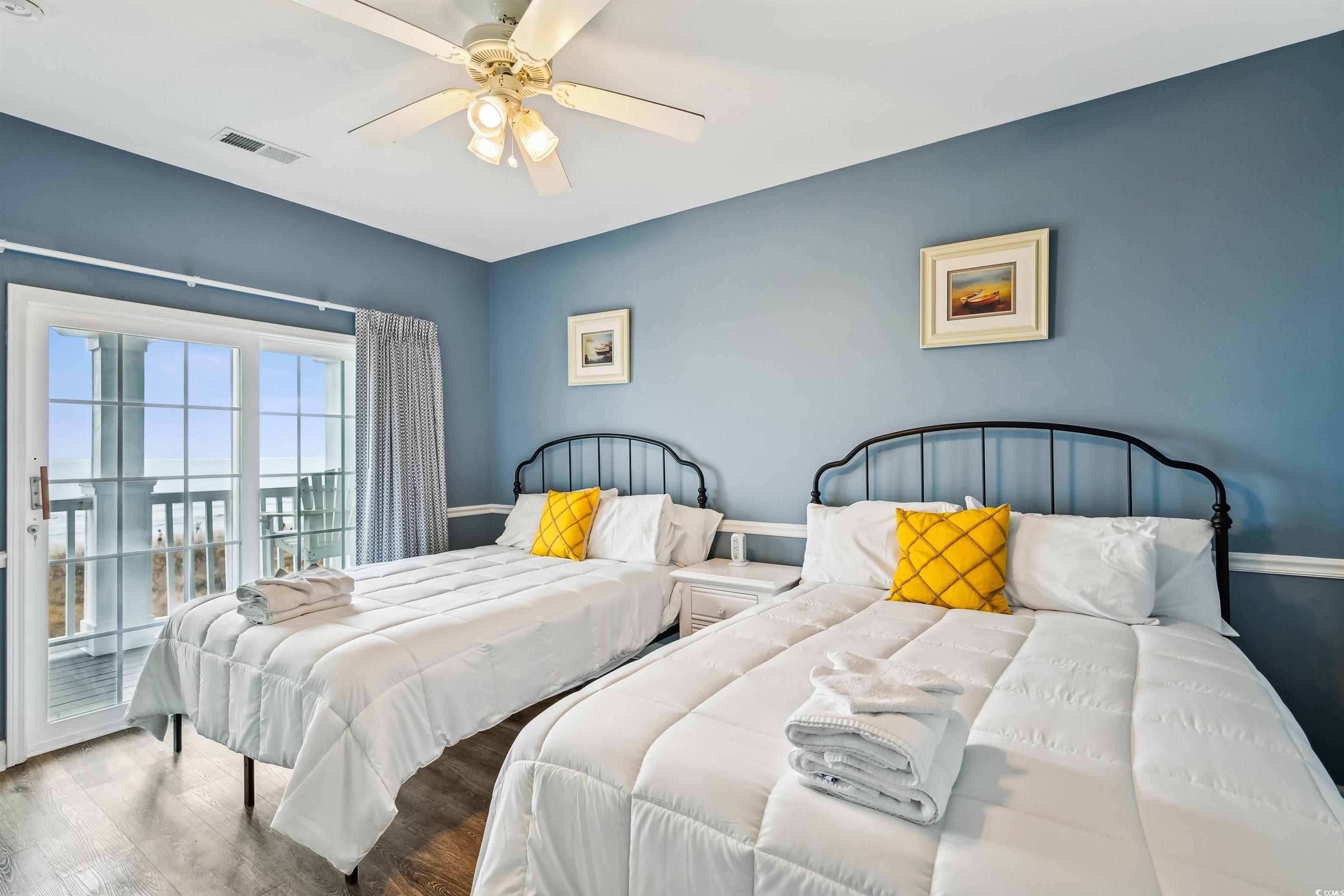 931 South Ocean Boulevard North Myrtle Beach, SC 29582 - Photo 15 of 40 Bedroom featuring access to outside, wood finished floors, and a ceiling fan