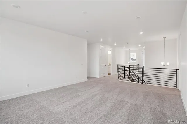 a view of an empty room with a kitchen