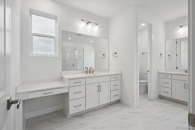 a spacious bathroom with double sink and a large mirror