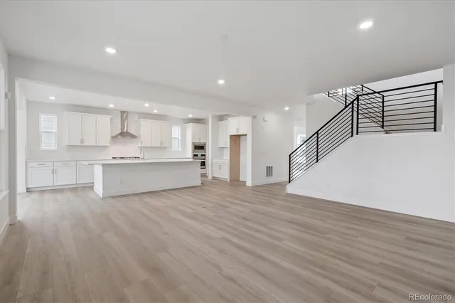 a view of kitchen with wooden floor and electronic appliances