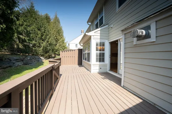 a view of a house with a wooden deck