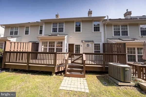 a view of a house with a wooden deck
