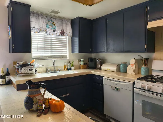 a kitchen with a sink cabinets and window