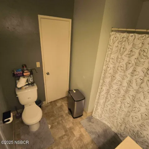 a bathroom with a toilet and a mirror