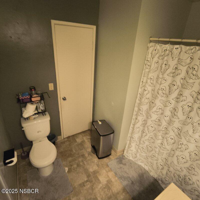413 East Park Avenue, Unit C3 Santa Maria, CA 93454 - Photo 14 of 26 a bathroom with a toilet and a mirror