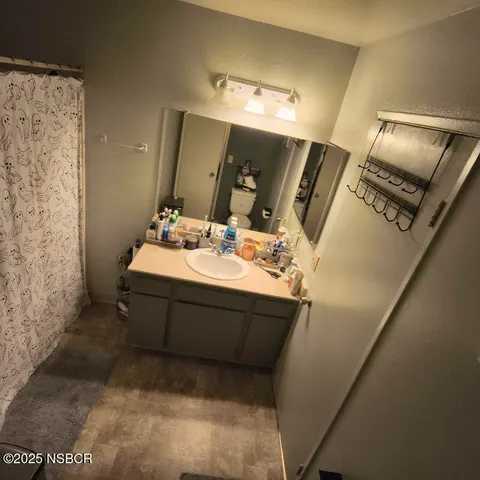 a bathroom with a sink vanity and mirror