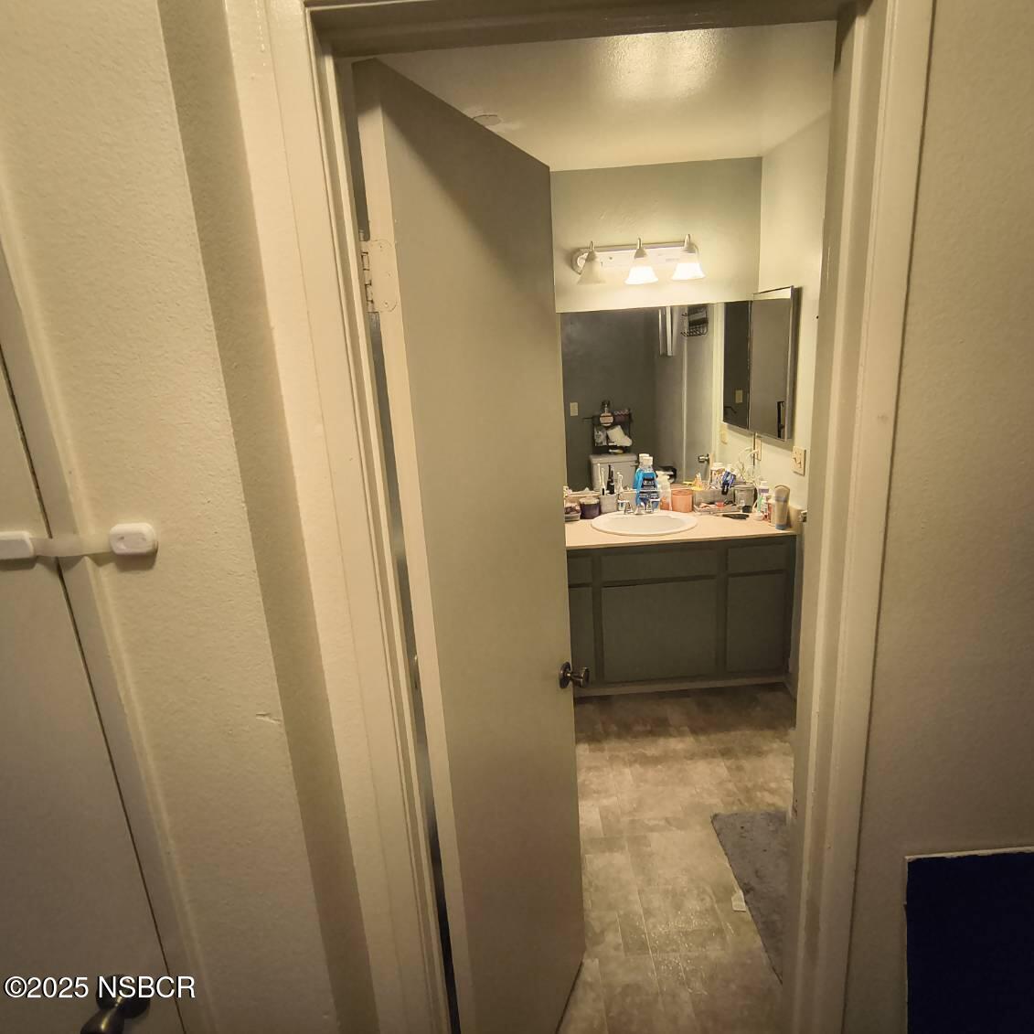 413 East Park Avenue, Unit C3 Santa Maria, CA 93454 - Photo 16 of 26 a bathroom with sink a mirror a vanity and window