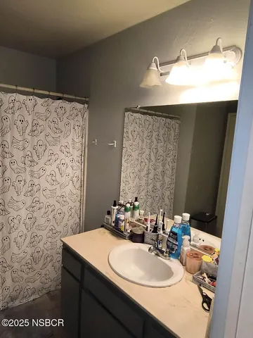 a bathroom with a sink vanity mirror and a toilet
