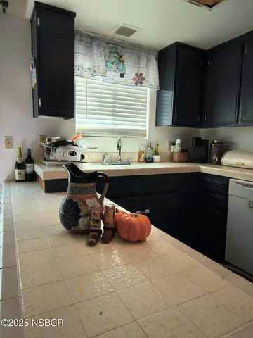 a kitchen with a sink and cabinets