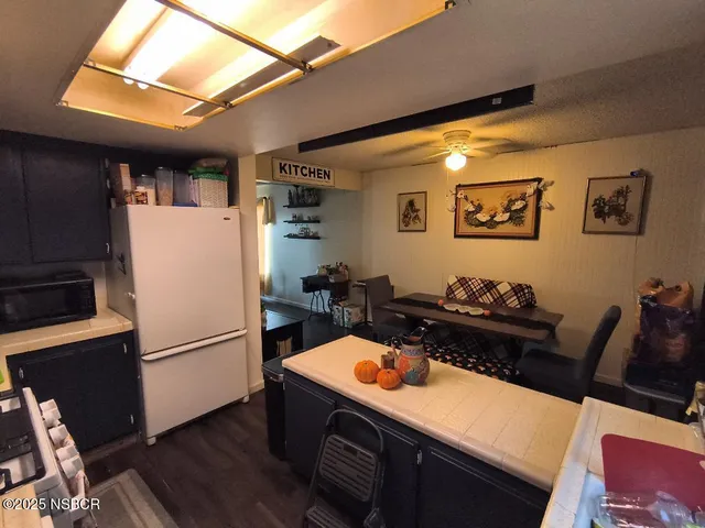 a kitchen with a refrigerator and a stove top oven