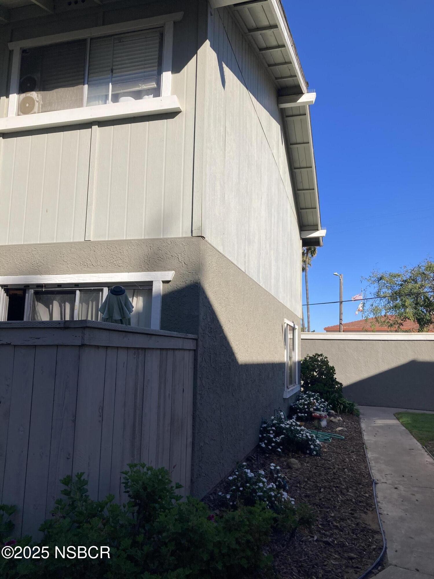 413 East Park Avenue, Unit C3 Santa Maria, CA 93454 - Photo 7 of 26 a view of a house with a yard and wooden fence
