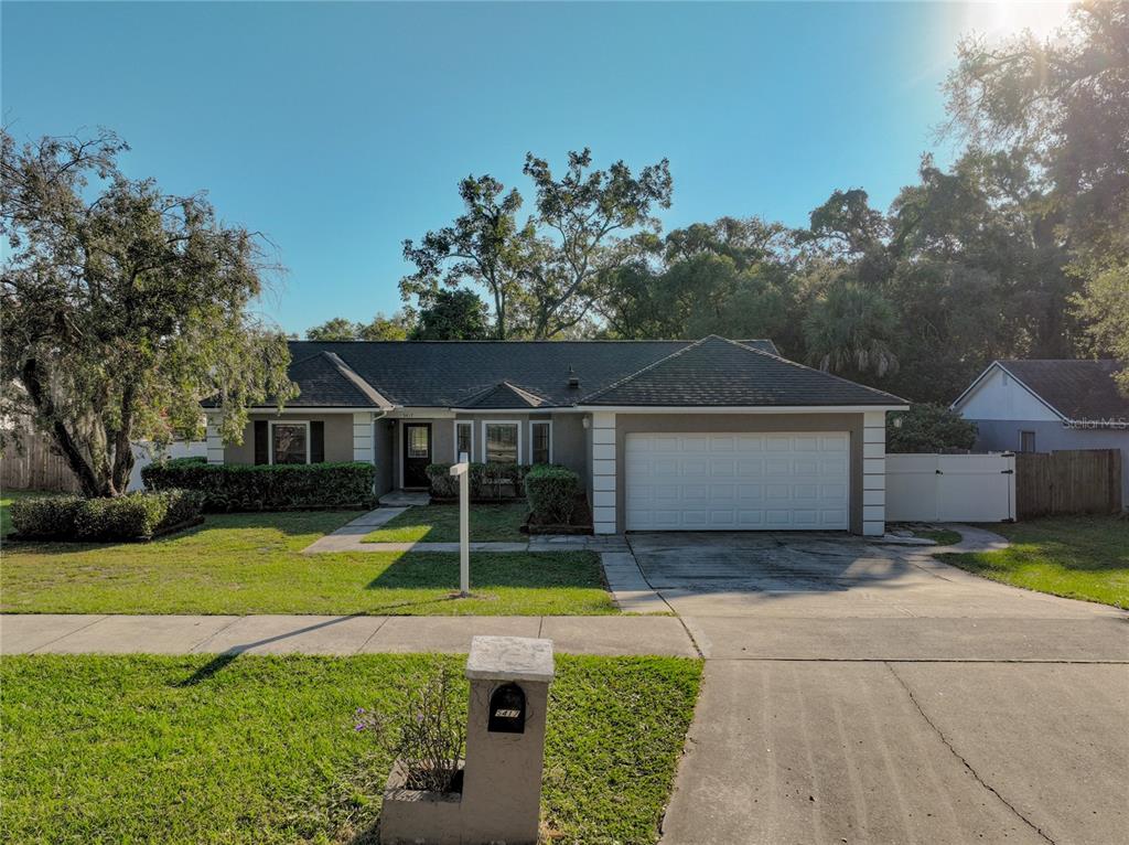 a front view of a house with yard and green space