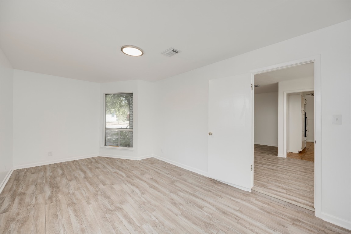 4710 Roundup Trail Austin, TX 78745 - Photo 15 of 26 a view of empty room with wooden floor and fan