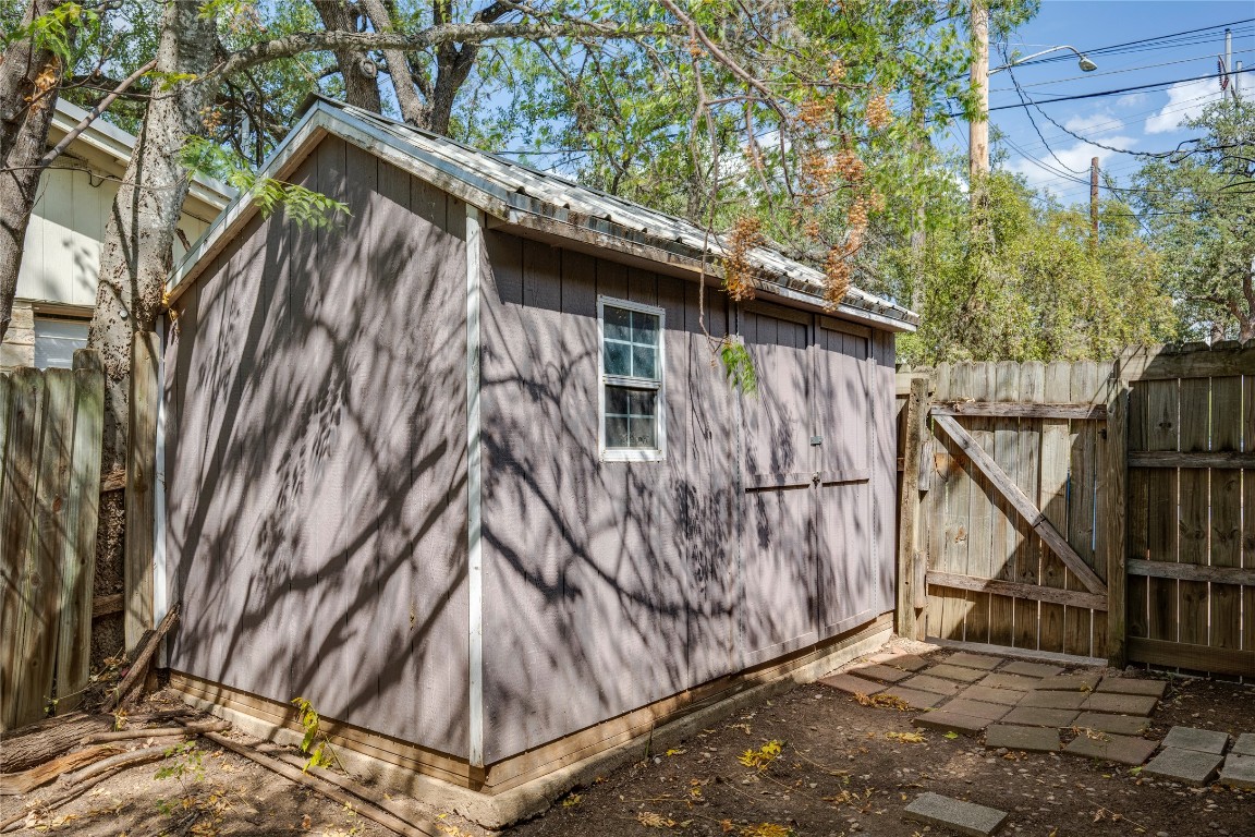 4710 Roundup Trail Austin, TX 78745 - Photo 19 of 26 a view of backyard with small cabin and wooden fencing